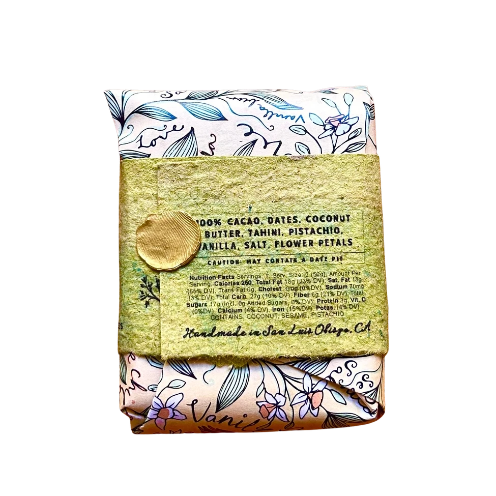 A packaged food product wrapped in a floral patterned cloth and tied with a textured olive-green paper band featuring a gold wax seal, shown on a plain white background.