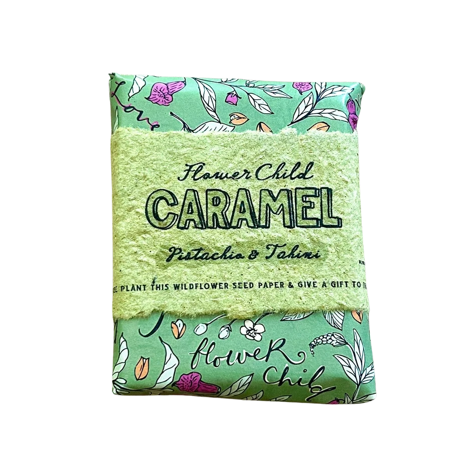 A packaged seed paper product labeled 'Flower Child Caramel Pistachio & Tahiti' with a light green textured center and mint green patterned top and bottom, shown on a plain white background.