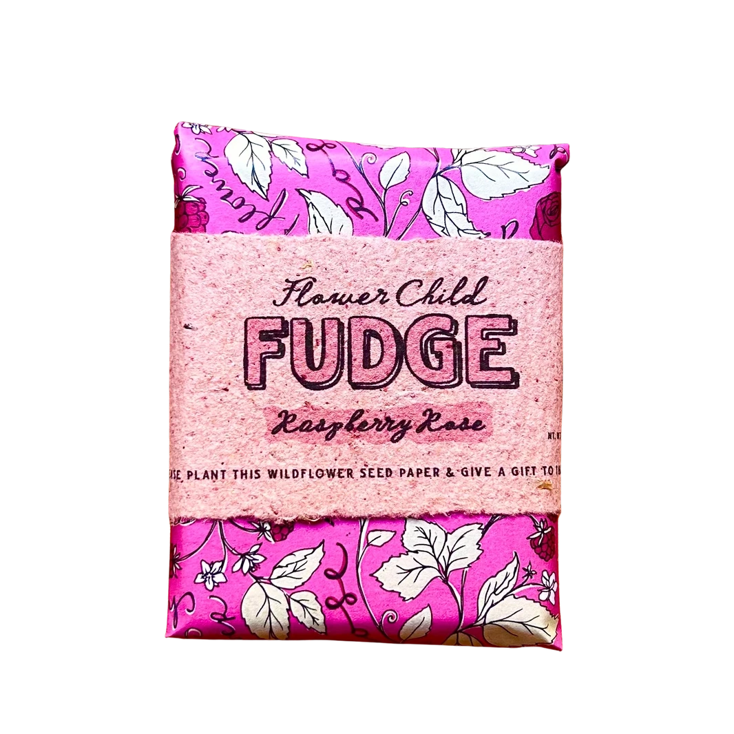 A pink scented flower seed paper wrapped in a paper band labeled 'Flower Child FUDGE Raspberry Rose' on a plain white background.