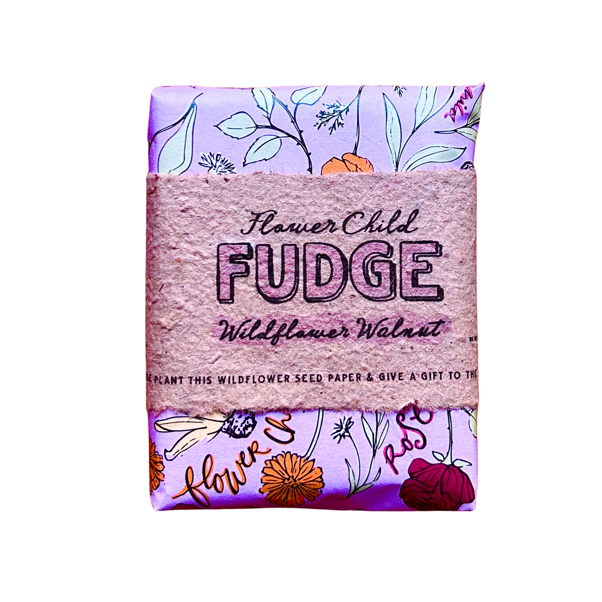 A packaged bar of Flower Child Fudge Wildflower Walnut fudge, wrapped in a textured pink paper band with floral illustrations on a light purple background.